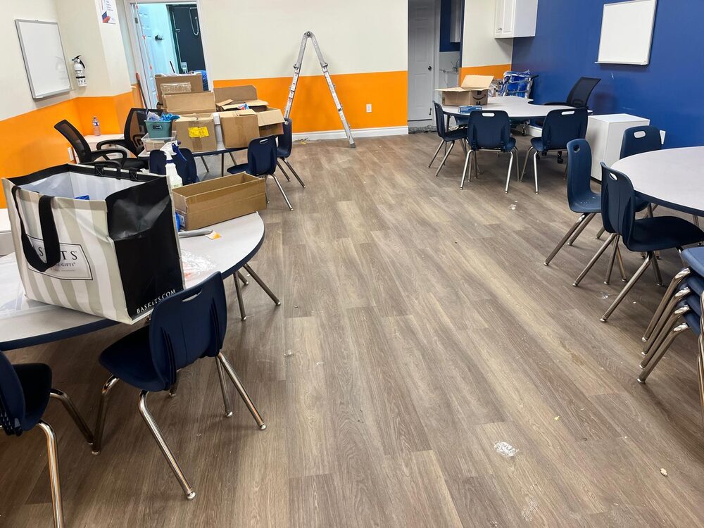 Classroom before the Mathi Cleaning Services move-in clean, with boxes and furniture to clear