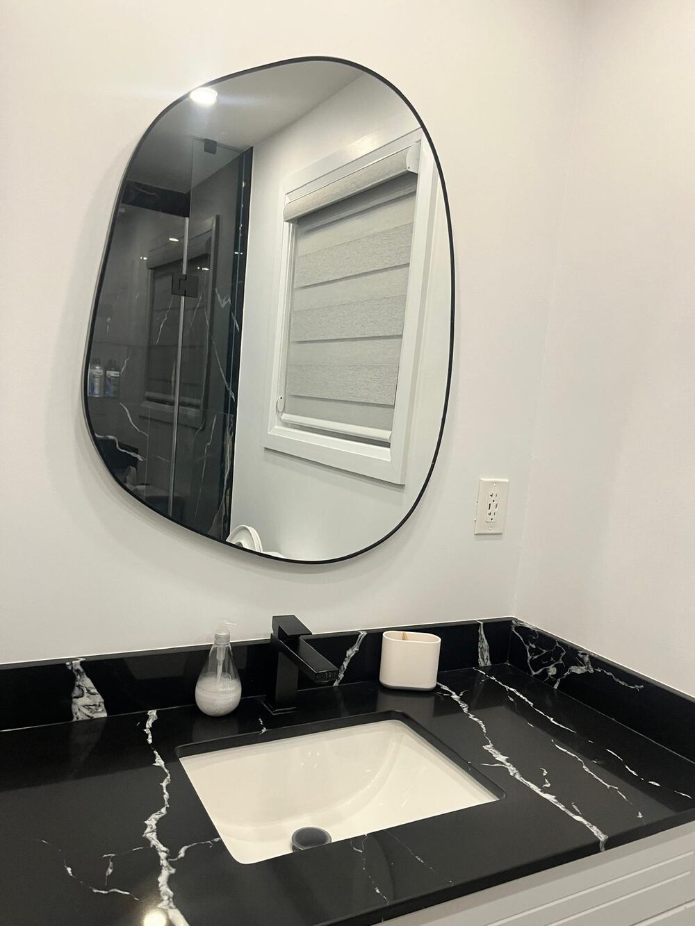 Black marble vanity and mirror cleaned to a shine